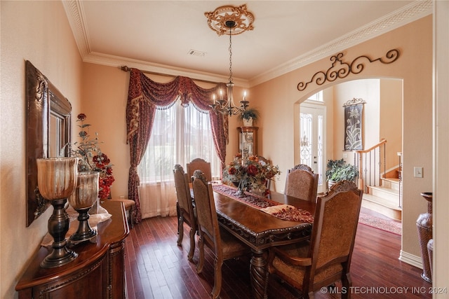 dining space featuring a notable chandelier, crown molding, and dark wood-type flooring