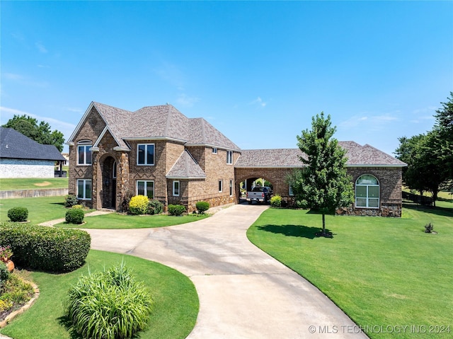 view of front of home with a front yard and a carport