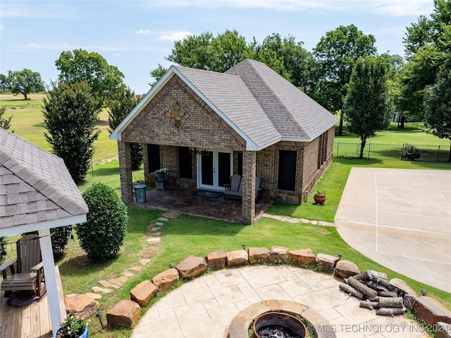 view of patio / terrace featuring french doors and a fire pit