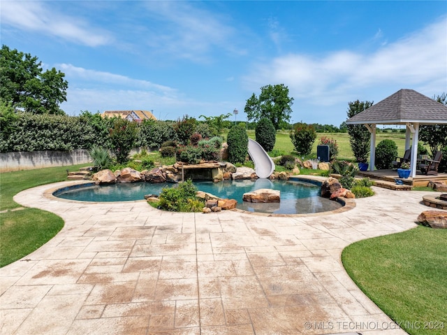 view of pool with a gazebo, a patio area, a yard, and a water slide