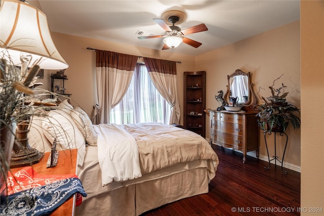 bedroom with ceiling fan and dark hardwood / wood-style flooring