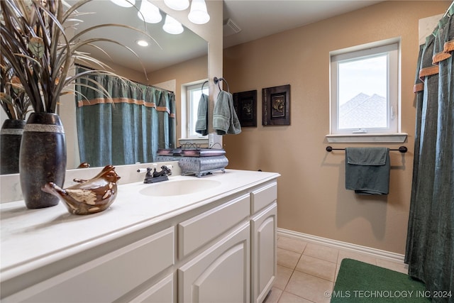 bathroom with tile patterned flooring and vanity