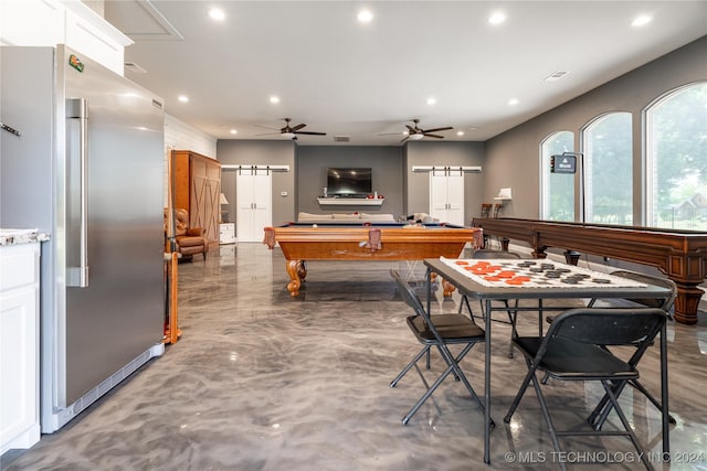 game room featuring ceiling fan, a barn door, concrete floors, and billiards