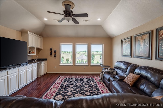 living room featuring lofted ceiling, ceiling fan, sink, and dark hardwood / wood-style floors