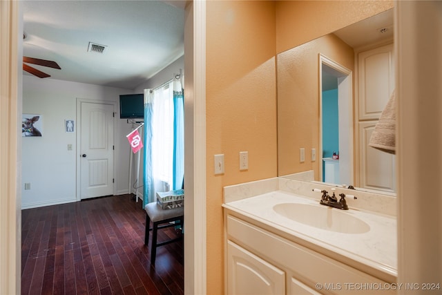 bathroom featuring wood-type flooring, vanity, and ceiling fan