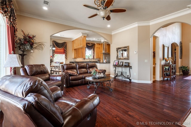 living room featuring hardwood / wood-style flooring, ceiling fan, and crown molding