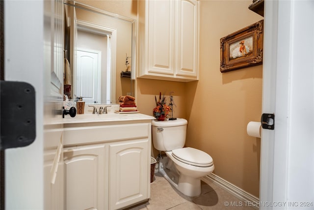 bathroom with tile patterned flooring, vanity, and toilet