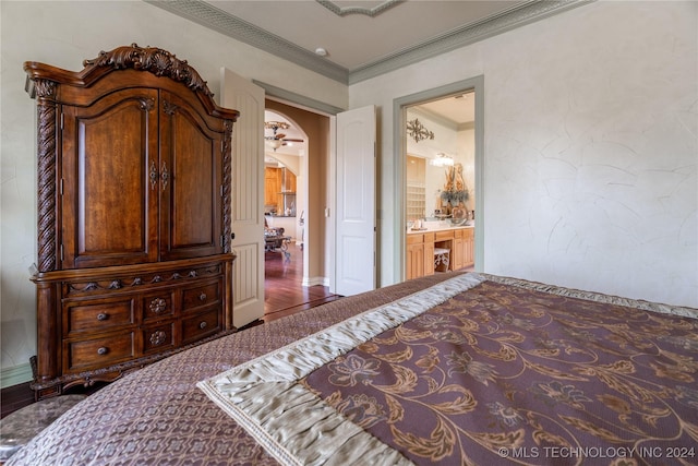 bedroom featuring ensuite bath and crown molding