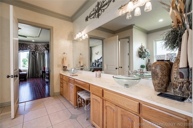 bathroom featuring tile patterned flooring, vanity, and ornamental molding