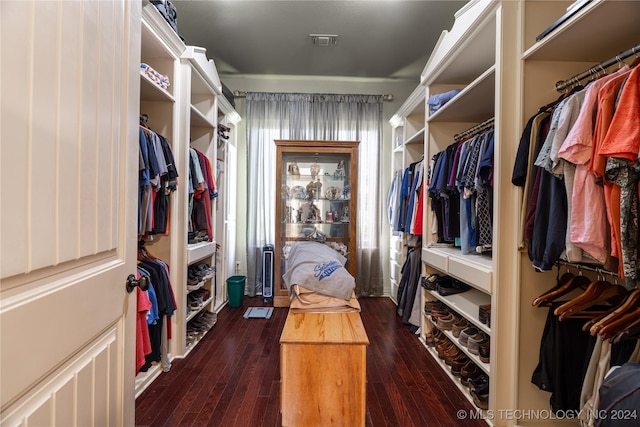 walk in closet with dark hardwood / wood-style floors