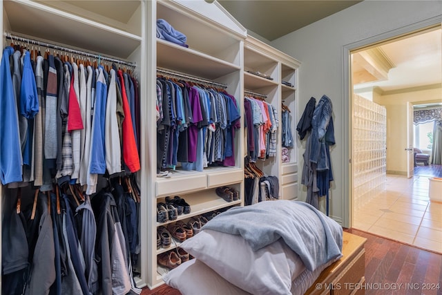 walk in closet with hardwood / wood-style floors