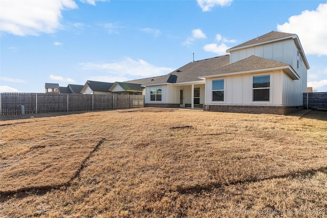 rear view of house with a lawn