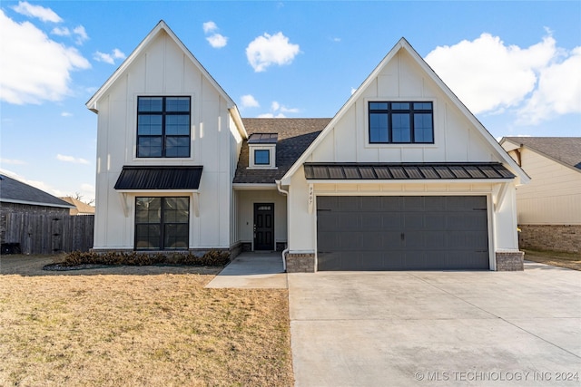 modern farmhouse style home featuring a garage and a front lawn