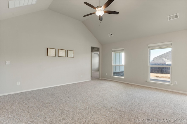 empty room featuring carpet, vaulted ceiling, and ceiling fan