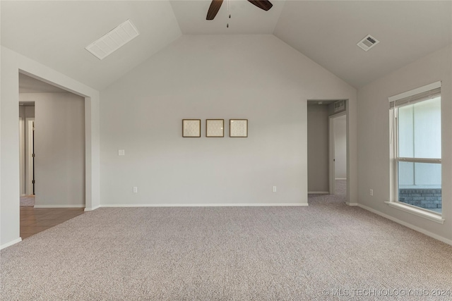 carpeted empty room featuring ceiling fan and lofted ceiling