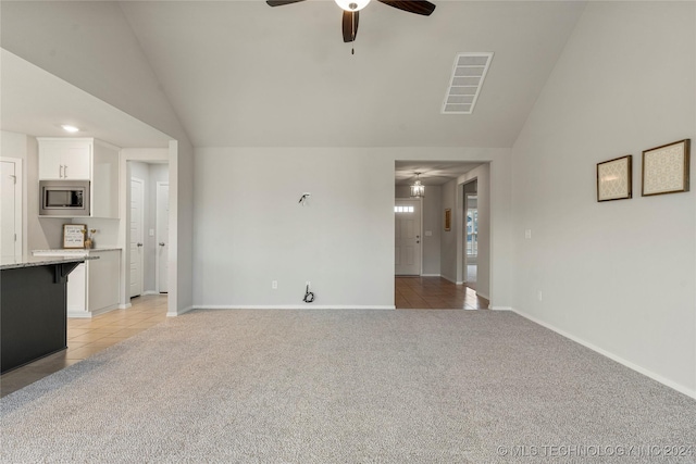 unfurnished living room featuring light colored carpet, ceiling fan, and lofted ceiling