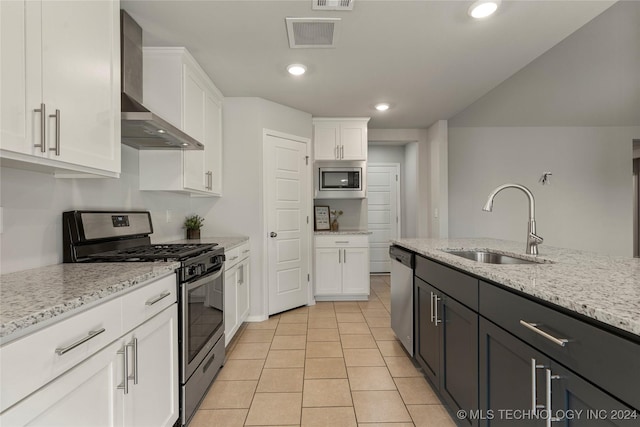 kitchen with white cabinets, wall chimney exhaust hood, and stainless steel appliances