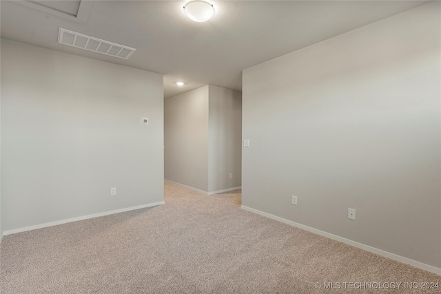 unfurnished room featuring light colored carpet