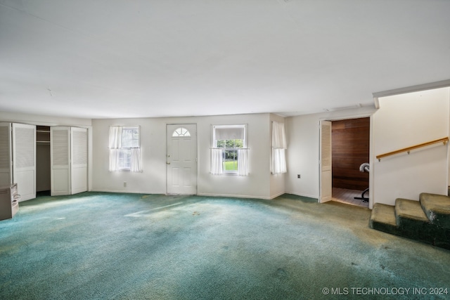 unfurnished living room with carpet