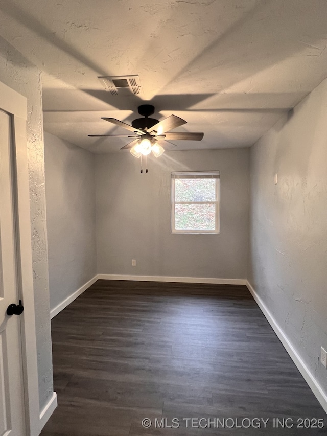 spare room featuring ceiling fan and dark hardwood / wood-style floors