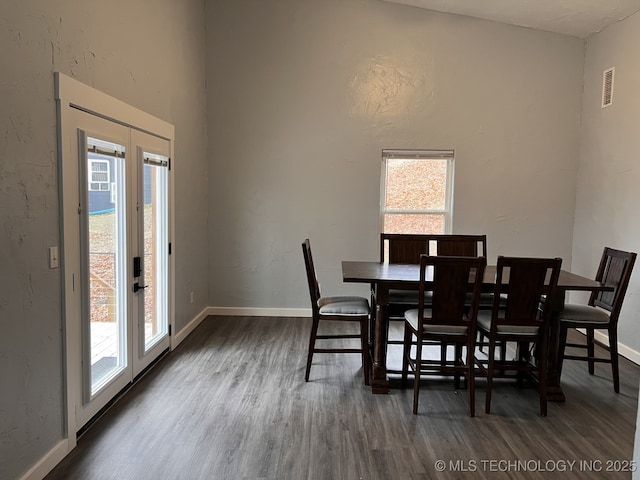 dining space with dark hardwood / wood-style flooring