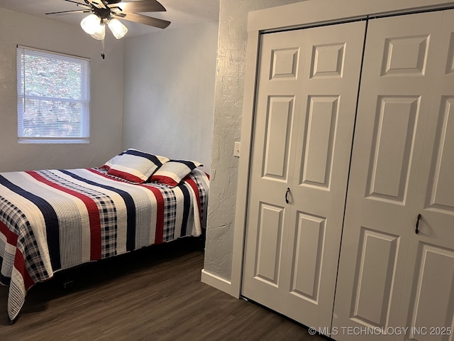 bedroom with ceiling fan, a closet, and dark wood-type flooring