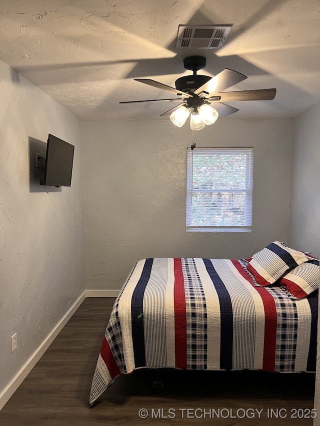 unfurnished bedroom with ceiling fan and dark hardwood / wood-style floors