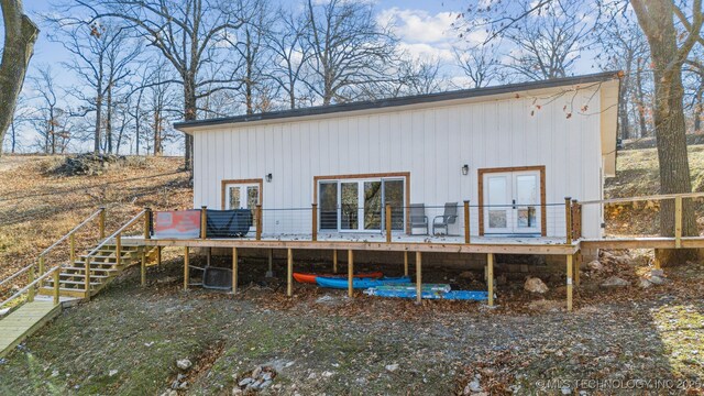 rear view of house featuring a wooden deck and french doors