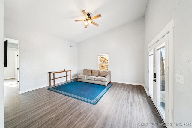 unfurnished room with a wealth of natural light, dark hardwood / wood-style flooring, ceiling fan, and high vaulted ceiling