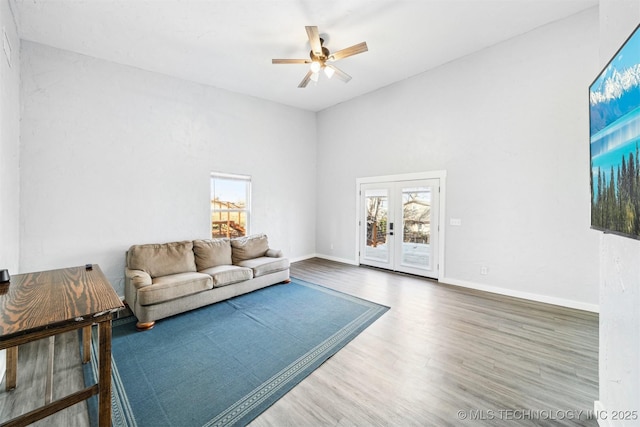 living room with hardwood / wood-style floors, ceiling fan, plenty of natural light, and french doors