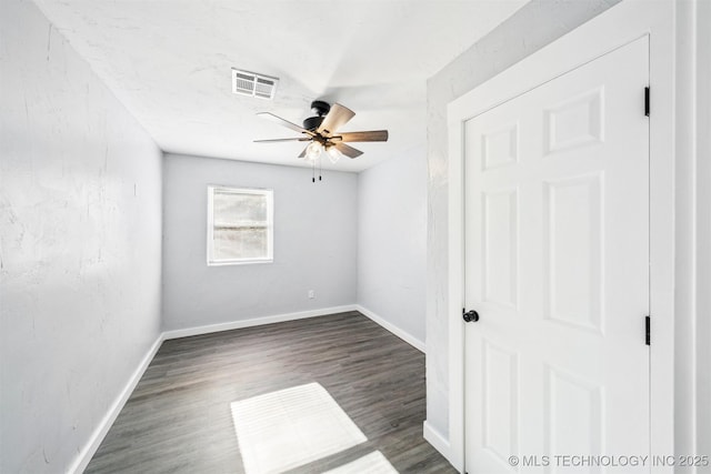 unfurnished room with ceiling fan and dark hardwood / wood-style floors