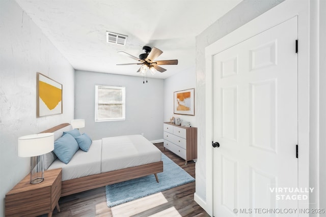 bedroom featuring ceiling fan and dark hardwood / wood-style floors