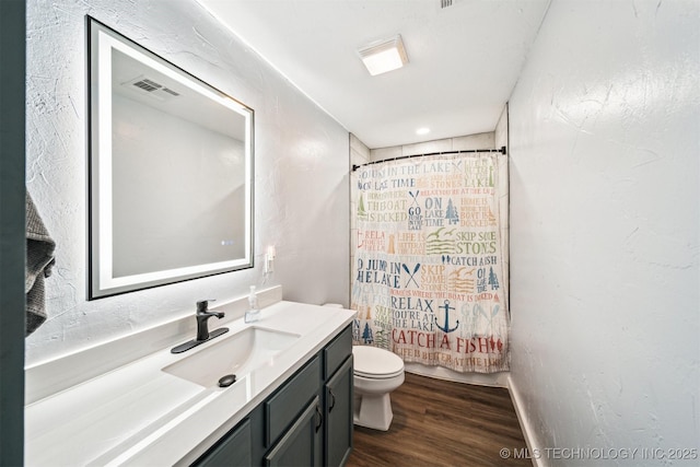 full bathroom featuring hardwood / wood-style flooring, vanity, toilet, and shower / bath combo with shower curtain