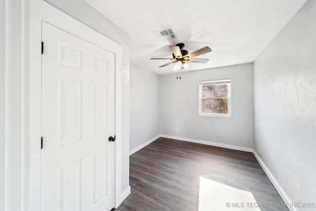 unfurnished bedroom featuring dark hardwood / wood-style floors and ceiling fan