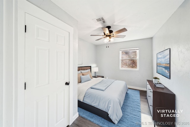 bedroom with hardwood / wood-style floors and ceiling fan