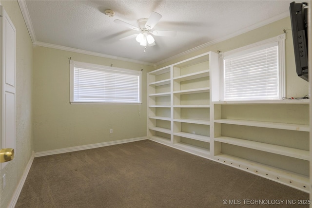 unfurnished room featuring ceiling fan, dark carpet, ornamental molding, and a textured ceiling