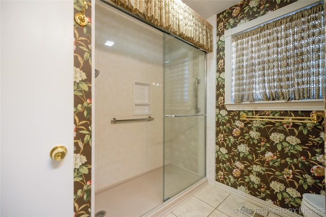 bathroom with tile patterned floors and an enclosed shower