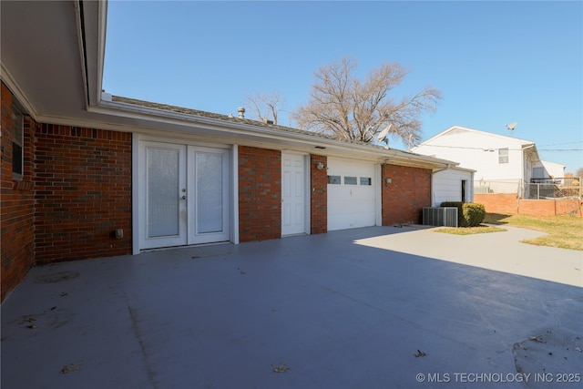 garage featuring central AC unit and french doors