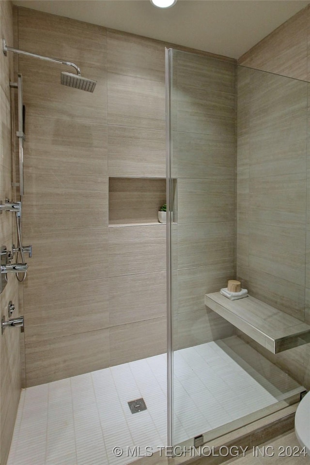 bathroom with tiled shower