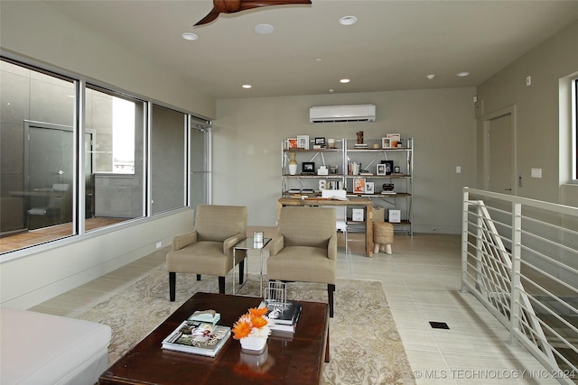 living room featuring a wall mounted AC, ceiling fan, and light tile patterned floors