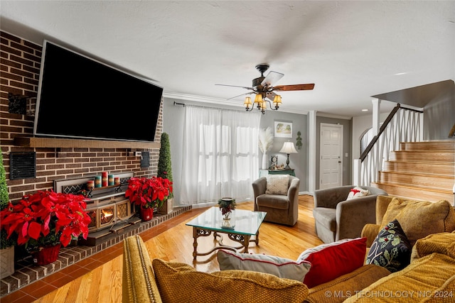 living room with ceiling fan, hardwood / wood-style floors, and crown molding