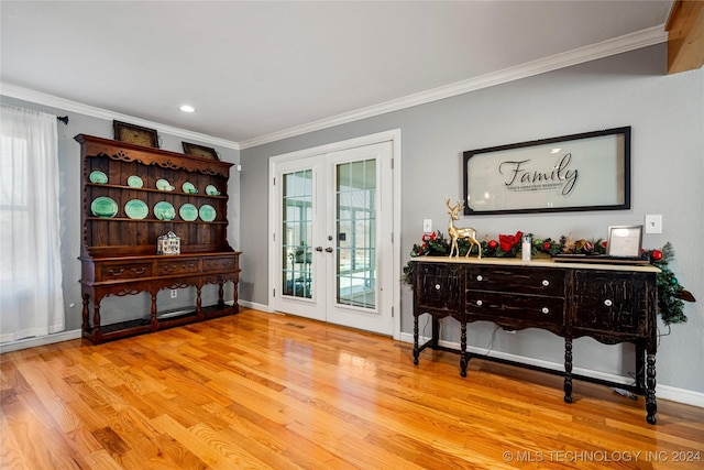 interior space featuring french doors, ornamental molding, plenty of natural light, and light hardwood / wood-style flooring