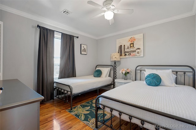 bedroom featuring hardwood / wood-style floors, ceiling fan, and ornamental molding