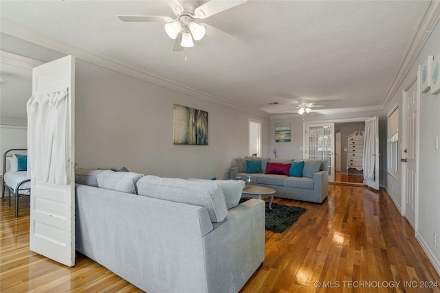 living room with hardwood / wood-style floors, ceiling fan, and ornamental molding