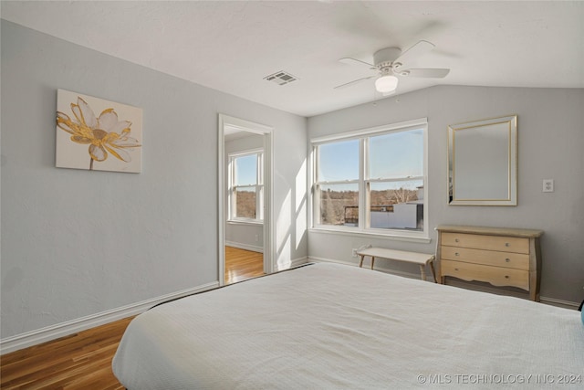 bedroom with hardwood / wood-style floors, ceiling fan, and vaulted ceiling