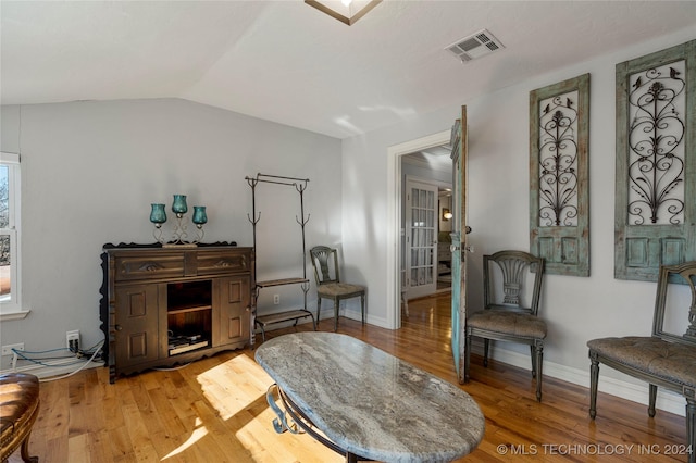 living area with hardwood / wood-style flooring and lofted ceiling