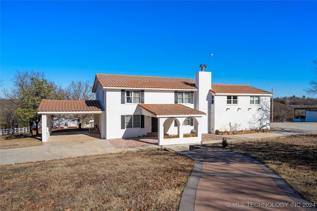 mediterranean / spanish house with a carport