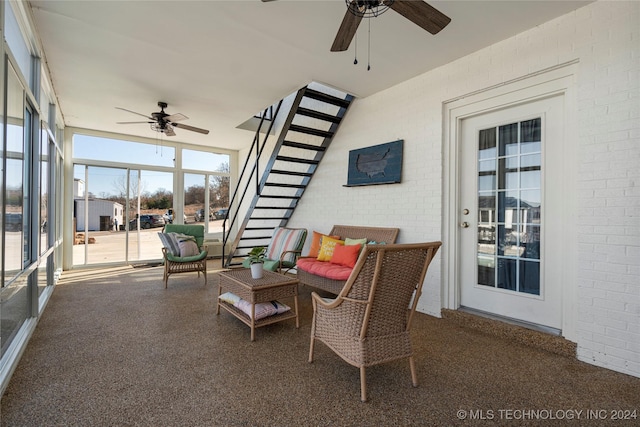 sunroom / solarium featuring ceiling fan