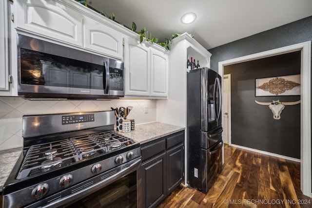 kitchen featuring tasteful backsplash, dark wood-type flooring, white cabinets, and stainless steel appliances