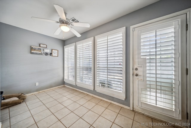 doorway to outside featuring ceiling fan and light tile patterned floors